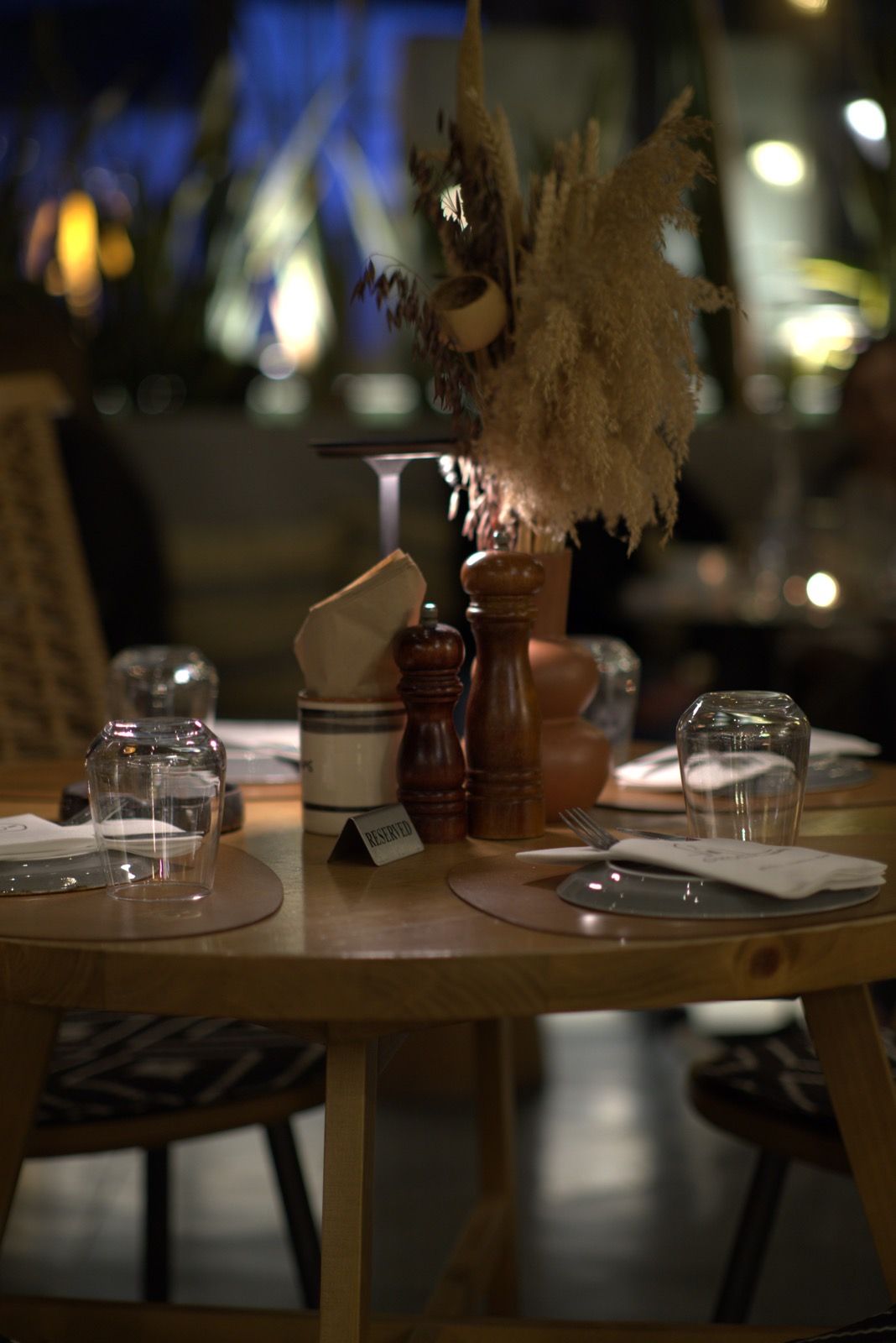 A reserved table at OIKOS at night